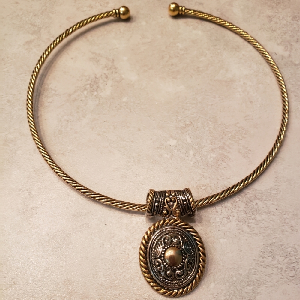 Beautiful gold choker necklace with detachable gold and silver medallion.